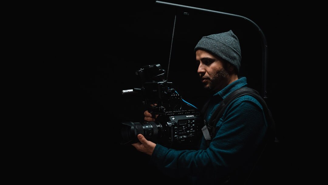 Monteuse vidéo suisse travaillant sur une timeline de montage dans un studio sombre
